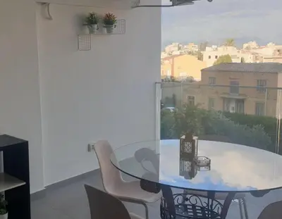 a dining room with a glass table and chairs at Deluxe 1 Bed Apt Ayios Dometios in Ayios Dhometios