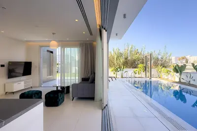 a living room with a swimming pool in a house at City Napa Seaview Villas - Villa 8 in Ayia Napa