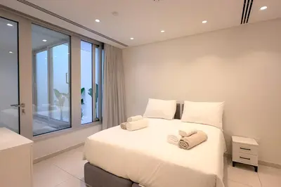 a bedroom with a large bed with towels on it at City Napa Seaview Villas - Villa 8 in Ayia Napa