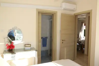 a room with a bed and a bathroom with a mirror at Villa Niki in Ayia Napa