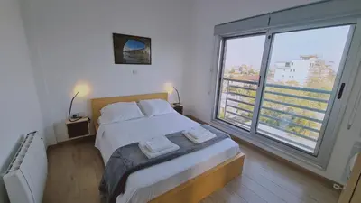 a bedroom with a bed and a large window at STAY Mystique Apartment in Limassol