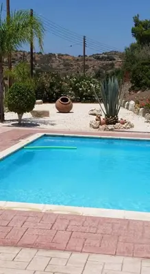 a large blue swimming pool in a yard at Villa Melyia in Kato Pyrgos