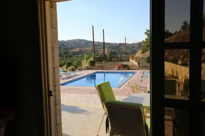 a view of a swimming pool from a window at Villa Melyia in Kato Pyrgos