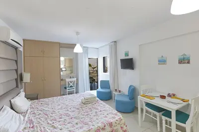 a bedroom with a bed and a table and chairs at Napa Hera 's Nest in Ayia Napa