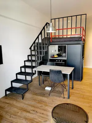 a dining room with a table and a loft bed at Unique City Centre Apartments in Nicosia