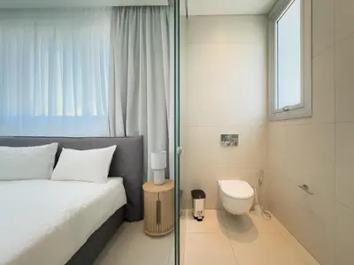 a bedroom with a bed and a toilet in it at City Napa Seaview Villas - Villa 7 in Ayia Napa