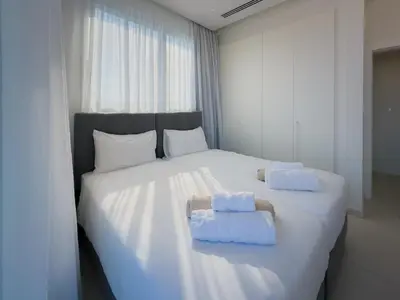 a bedroom with a large white bed with towels on it at City Napa Seaview Villas - Villa 7 in Ayia Napa