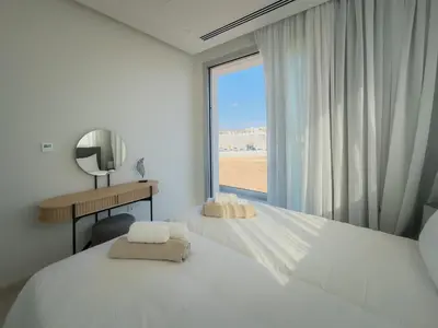 a bedroom with two beds and a large window at City Napa Seaview Villas - Villa 7 in Ayia Napa