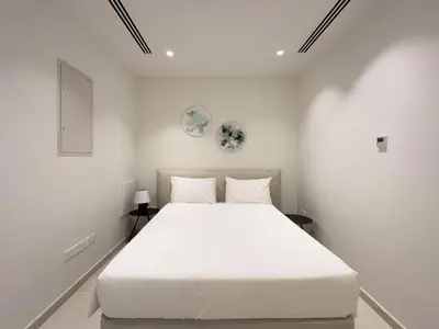 a white bedroom with a large white bed at City Napa Seaview Villas - Villa 7 in Ayia Napa