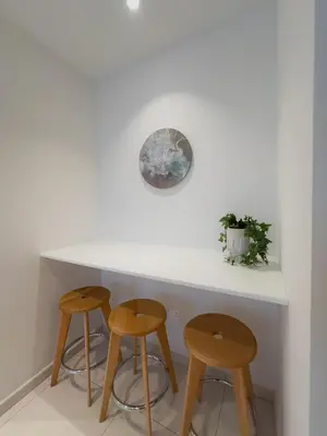 a kitchen with two stools and a white counter at City Napa Seaview Villas - Villa 7 in Ayia Napa