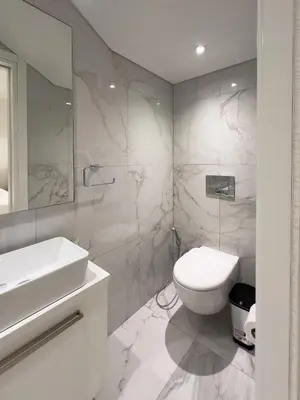 a white bathroom with a toilet and a sink at City Napa Seaview Villas - Villa 7 in Ayia Napa