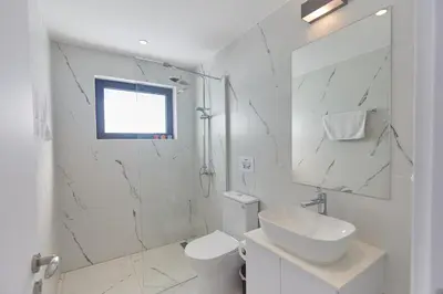 a white bathroom with a sink and a toilet at Protaras Elite Pearl Villa Ep4b in Protaras