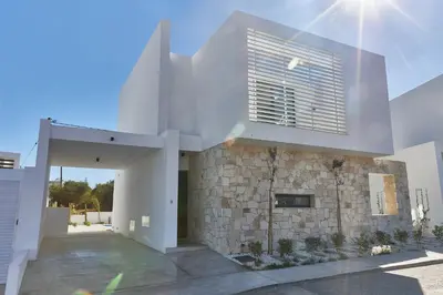a large white building with a stone wall at Protaras Elite Pearl Villa Ep4b in Protaras