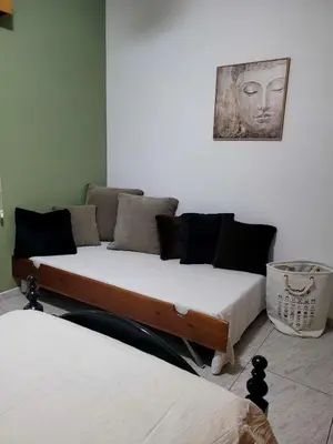 a room with two beds and a couch at Beautiful bedroom in Limassol