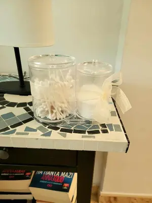 two glass jars sitting on top of a table at Μοναδικό δωμάτιο in Limassol