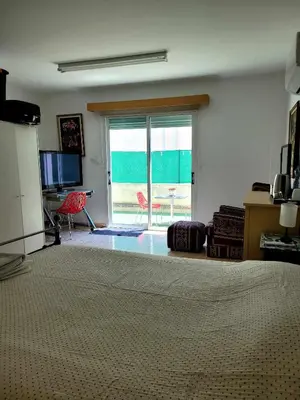 a bedroom with a bed and a view of the ocean at Μοναδικό δωμάτιο in Limassol