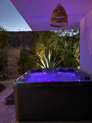 a hot tub with purple lighting in a backyard at Mountain Retreat in Troodos