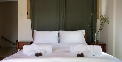 a white bed with white sheets and pillows at Mountain Retreat in Troodos
