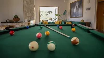 a pool table with balls and cuesticks on it at Mountain Retreat in Troodos