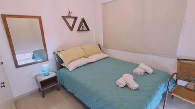 a bedroom with a bed with two pillows and a mirror at STAY Naturaleza Penthouse in Limassol