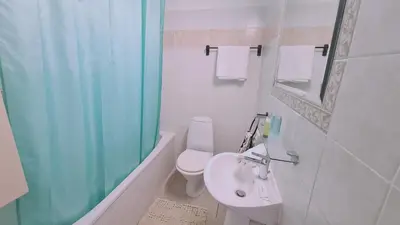 a bathroom with a toilet and a sink and a shower at STAY Naturaleza Penthouse in Limassol