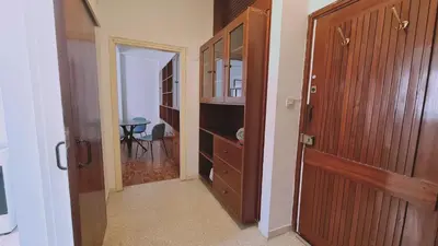 a hallway with a closet and a wooden door at STAY Antique Apartment in Larnaka