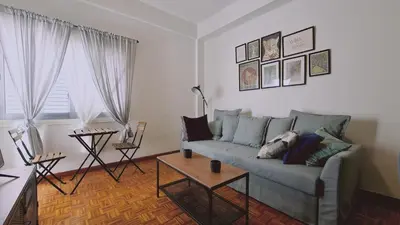 a living room with a couch and a table at STAY Antique Apartment in Larnaka