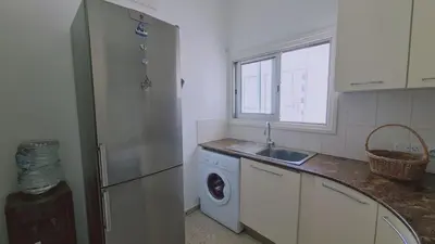 a kitchen with a refrigerator and a washing machine at STAY Antique Apartment in Larnaka