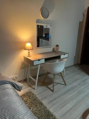 a desk with a mirror and a chair in a room at Ellados 20 in Limassol