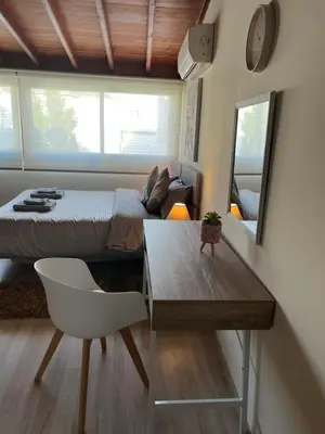 a bedroom with a bed and a table and a chair at Ellados 20 in Limassol