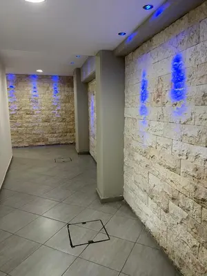 a room with a stone wall and blue lights at Ellados 20 in Limassol
