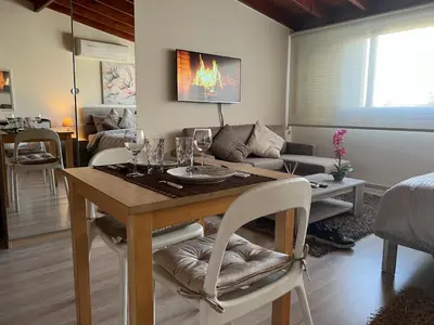 a living room with a table with wine glasses on it at Ellados 20 in Limassol
