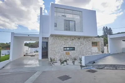 a white house with a stone facade at Protaras Elite Pearl Ville Ep3c in Protaras
