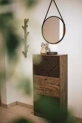 a mirror on top of a wooden dresser at Sunrise Beach Apartments in Larnaka