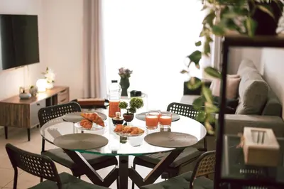 a table with food on it in a living room at Sunrise Beach Apartments in Larnaka