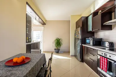 a kitchen with a table with oranges on a plate on it at Central Bliss / your perfect home away from home in Limassol