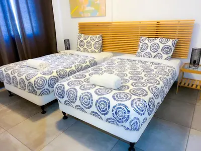 two beds sitting next to each other in a bedroom at Panoramic Sea View Apt - 2bed in Limassol
