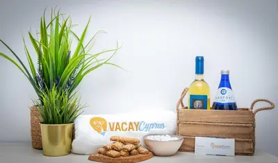 a table with a basket of wine bottles and peanuts at Seaview Apartment (Excellent Location) in Larnaka