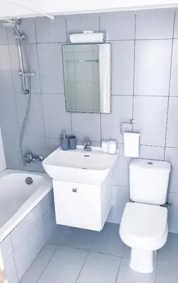 a bathroom with a sink and a toilet and a mirror at Seaview Apartment (Excellent Location) in Larnaka