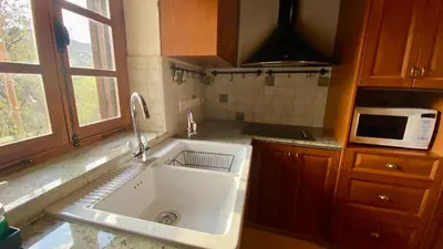 a kitchen with a sink and a microwave at Juliet Suite by TrulyCyprus in Doros