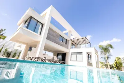 a house with a swimming pool in front of it at Luxury Panorama Villa Protaras in Protaras