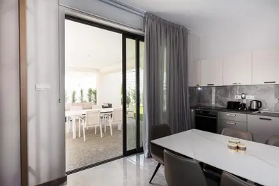 a kitchen with a table and a kitchen with a dining room at Luxury Panorama Villa Protaras in Protaras