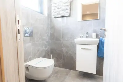 a bathroom with a toilet and a sink at Luxury Panorama Villa Protaras in Protaras