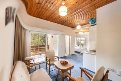 a living room with a table and chairs at Platres Forest Panorama Cottage in Platres