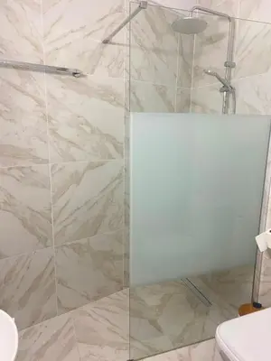 a shower with a glass door in a bathroom at Luxury City Retreat- 2-Bedroom, 2-Bath Apartment in Nicosia