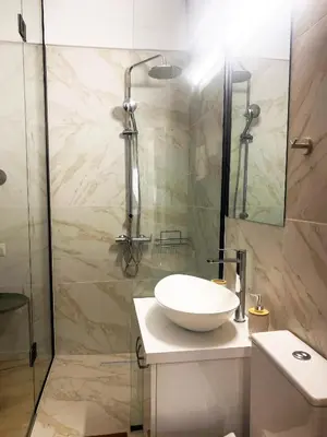 a bathroom with a sink and a shower at Luxury City Retreat- 2-Bedroom, 2-Bath Apartment in Nicosia