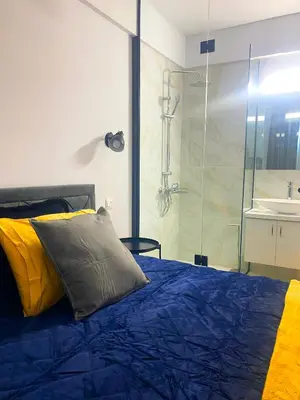 a bedroom with a bed and a glass shower at Luxury City Retreat- 2-Bedroom, 2-Bath Apartment in Nicosia