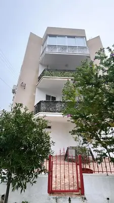 a building with a red gate in front of it at Luxury City Retreat- 2-Bedroom, 2-Bath Apartment in Nicosia