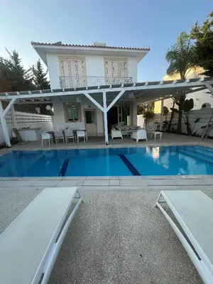 a villa with a swimming pool and a house at Riverland Turtle Beach Villa-1min walk to beach in Protaras