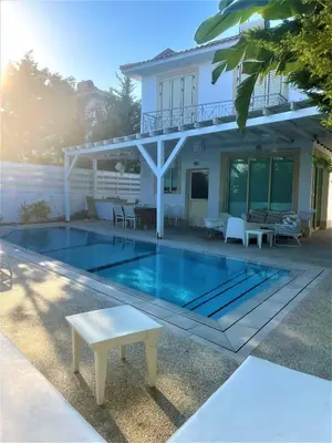 a house with a swimming pool in front of a house at Riverland Turtle Beach Villa-1min walk to beach in Protaras